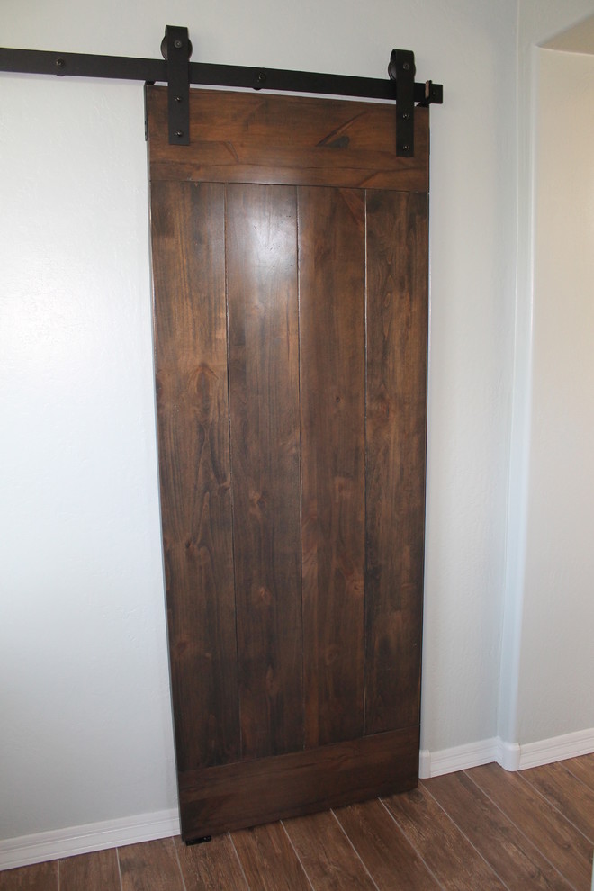 Example of a mid-sized transitional master beige tile and porcelain tile porcelain tile and brown floor hallway design in Phoenix with flat-panel cabinets, black cabinets, a two-piece toilet, an undermount sink, quartz countertops and gray walls