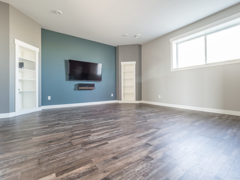 Mid-sized contemporary look-out basement in Edmonton with blue walls, vinyl floors and multi-coloured floor.