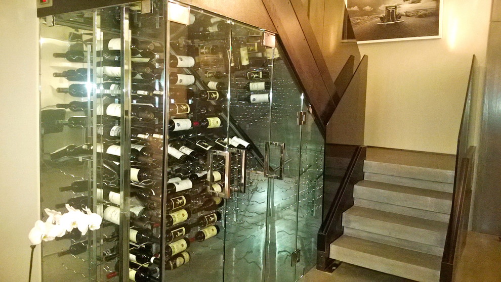 Design ideas for a mid-sized contemporary wine cellar in New York with marble floors and display racks.