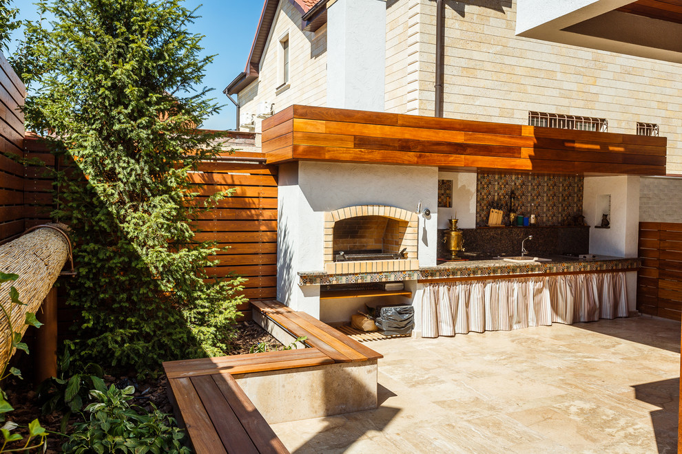 Inspiration for a mid-sized mediterranean backyard patio in Saint Petersburg with an outdoor kitchen.