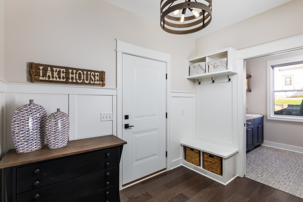 Mid-sized beach style mudroom in Grand Rapids with white walls, medium hardwood floors and brown floor.