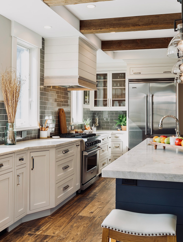 Large minimalist brown floor kitchen photo in Other with a farmhouse sink, beaded inset cabinets, white cabinets, granite countertops, stainless steel appliances, an island and white countertops