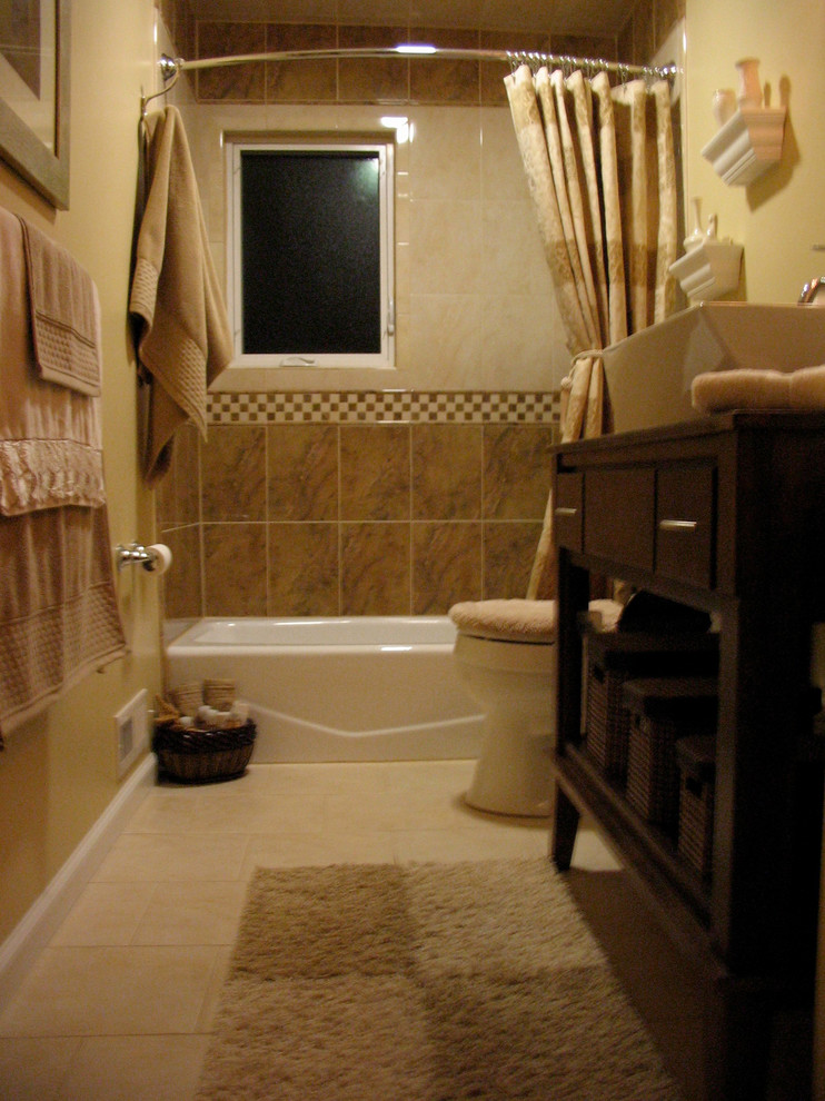 Inspiration for a mid-sized traditional 3/4 bathroom in Newark with flat-panel cabinets, dark wood cabinets, an alcove tub, a shower/bathtub combo, a one-piece toilet, yellow walls, ceramic floors, a vessel sink and wood benchtops.