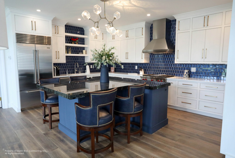 Example of a large transitional u-shaped open concept kitchen design with flat-panel cabinets, white cabinets, quartz countertops, blue backsplash, an island and white countertops