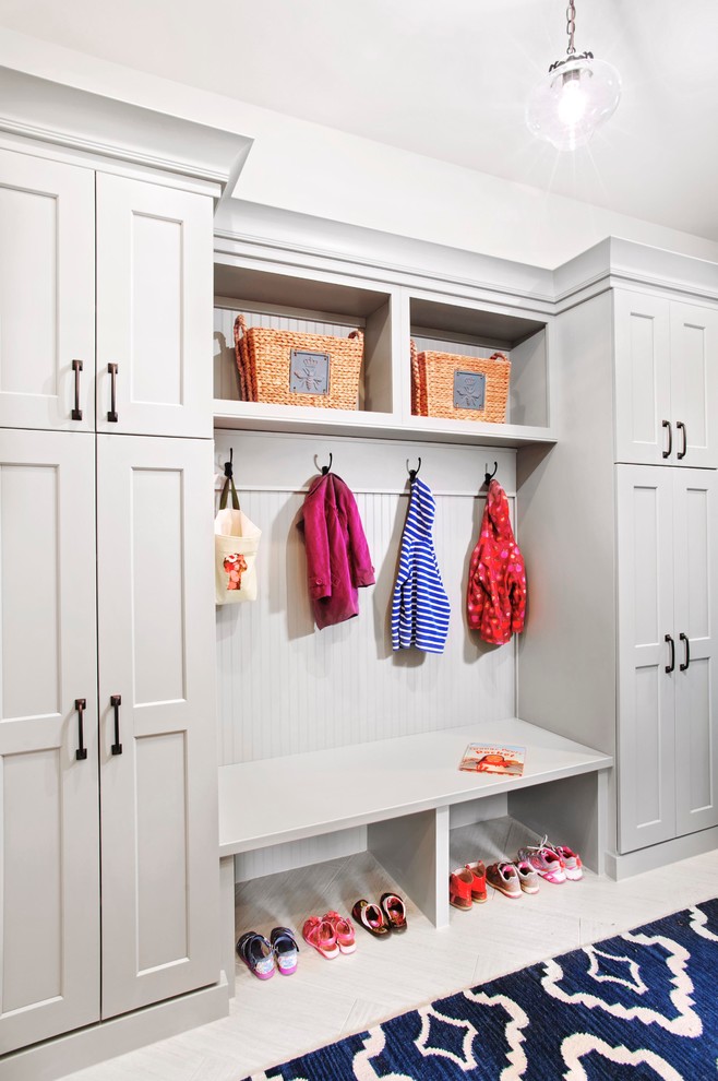 Example of a mid-sized transitional mudroom design in Denver with white walls