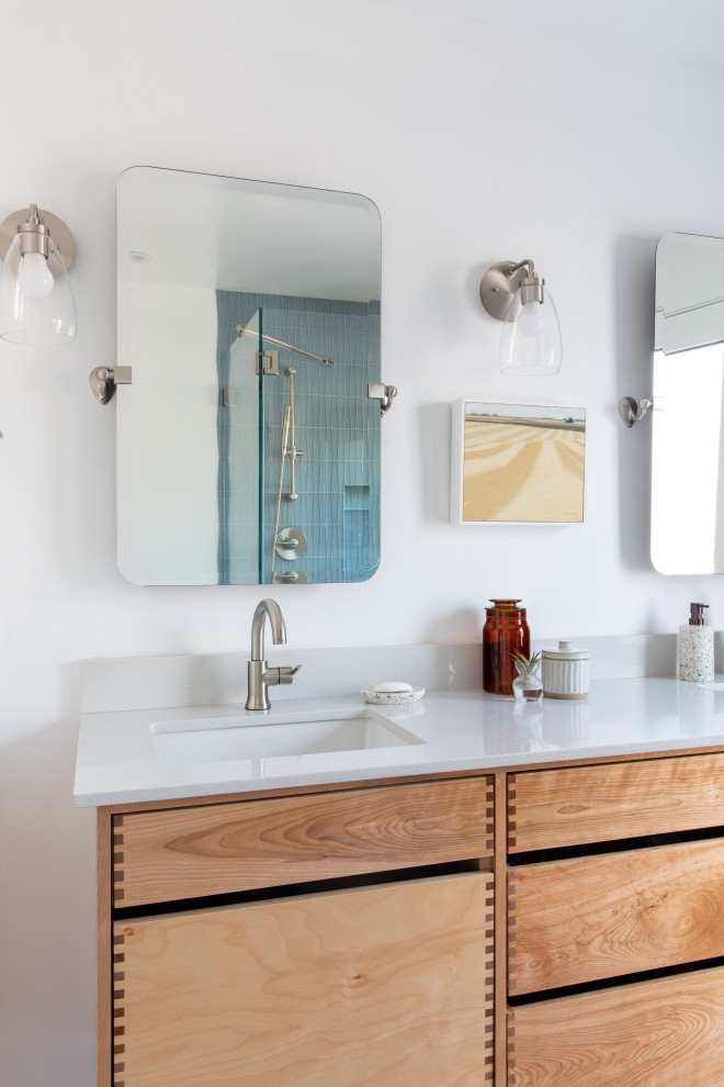 Photo of a mid-sized midcentury master bathroom in San Francisco with beaded inset cabinets, light wood cabinets, a double shower, a one-piece toilet, white tile, glass tile, white walls, porcelain floors, a drop-in sink, engineered quartz benchtops, grey floor, a hinged shower door, white benchtops, a double vanity and a floating vanity.