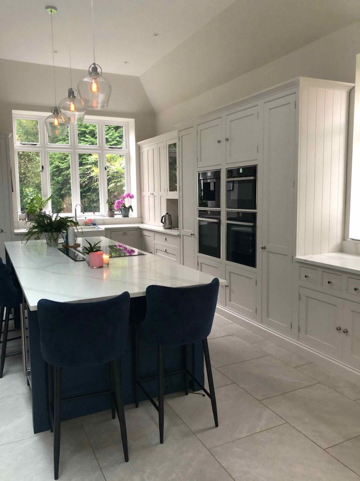 Inspiration for a large contemporary l-shaped open plan kitchen in Surrey with beaded inset cabinets, beige cabinets, quartzite benchtops and with island.