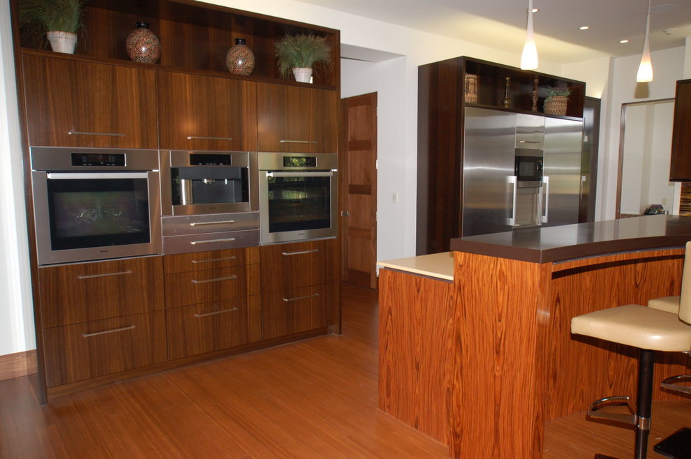 Kitchen - kitchen idea in Denver with stainless steel appliances and an island