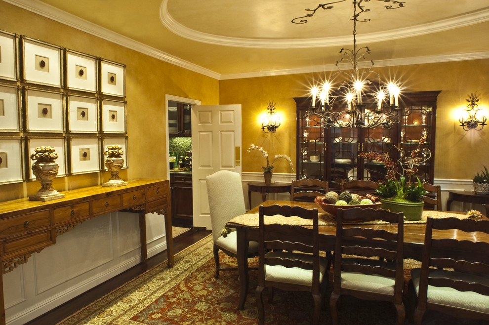 Inspiration for a traditional separate dining room in San Francisco with yellow walls and dark hardwood floors.