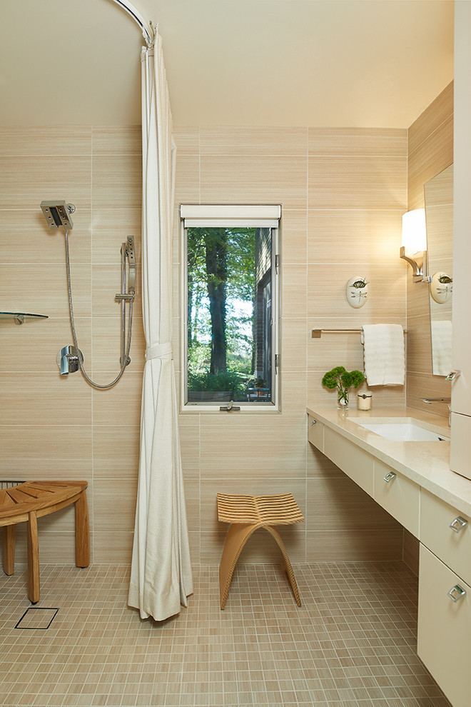 Walk-in shower - transitional beige tile single-sink and beige floor walk-in shower idea with flat-panel cabinets, an undermount sink, a floating vanity, beige cabinets, beige countertops and beige walls