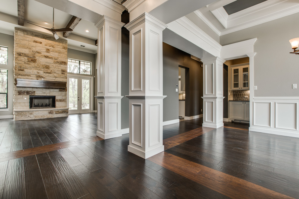 Inspiration for a large arts and crafts foyer in Austin with dark hardwood floors, multi-coloured walls, a single front door and a dark wood front door.