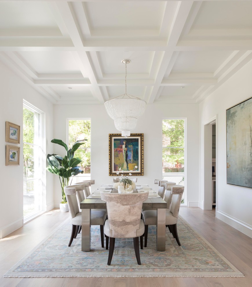 Inspiration for a mediterranean separate dining room in Dallas with white walls, light hardwood floors and no fireplace.