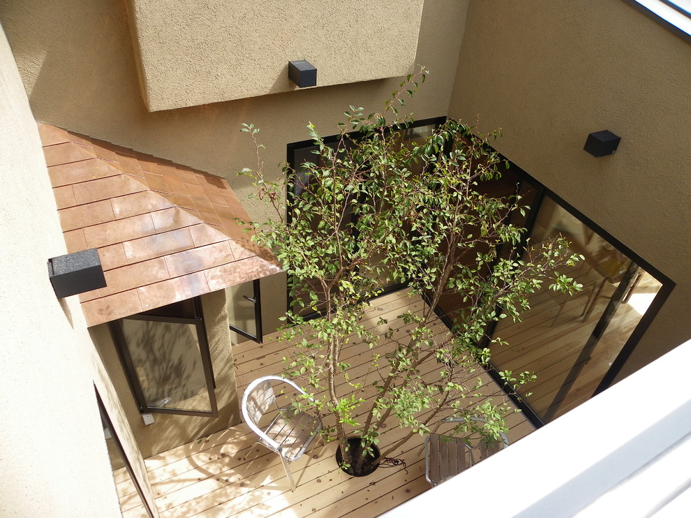 Photo of an asian courtyard patio in Other with decking and no cover.