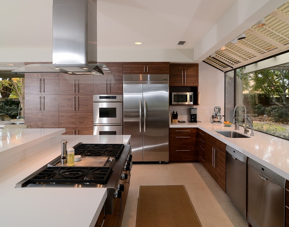 Photo of a contemporary galley open plan kitchen in Sacramento with an undermount sink, flat-panel cabinets, medium wood cabinets and stainless steel appliances.