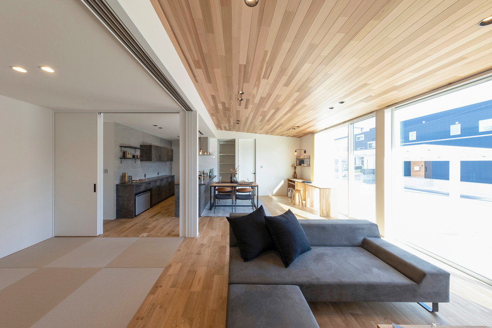 Inspiration for a zen open concept tatami floor, beige floor, wood ceiling and wallpaper family room remodel in Other with white walls, no fireplace and a wall-mounted tv