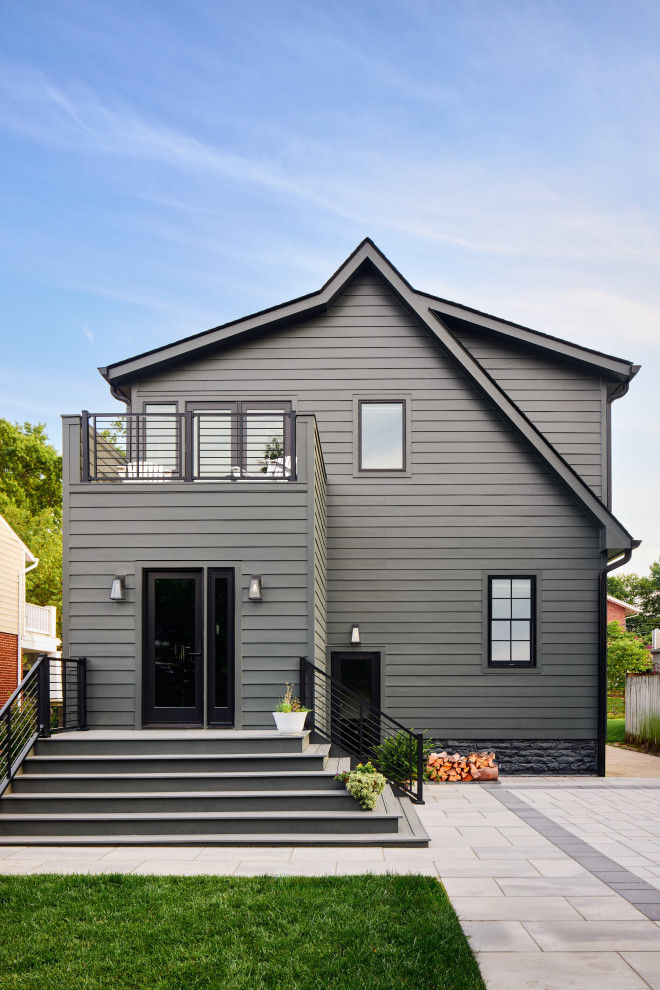 Example of a mid-sized transitional black two-story house exterior design in DC Metro with a black roof