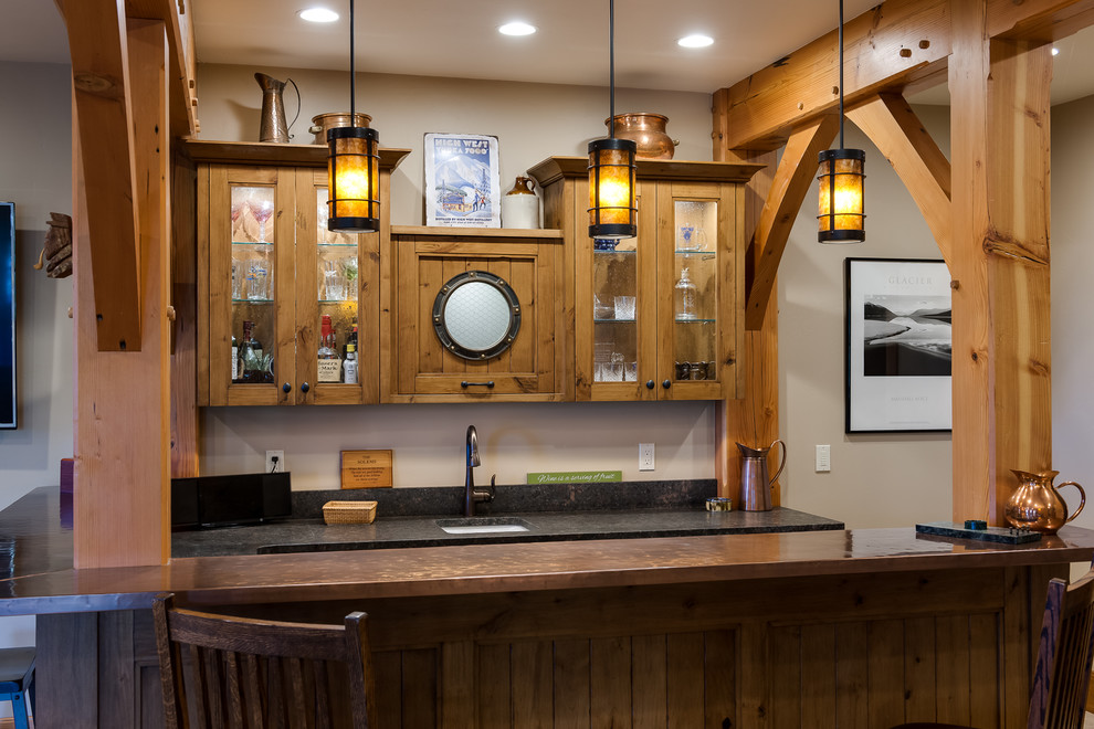 Photo of a mid-sized country u-shaped seated home bar in Seattle with an undermount sink, glass-front cabinets, light wood cabinets, granite benchtops, ceramic floors and beige floor.