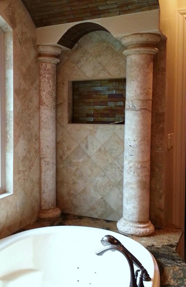 Example of a mid-sized master beige tile and stone tile drop-in bathtub design with multicolored walls