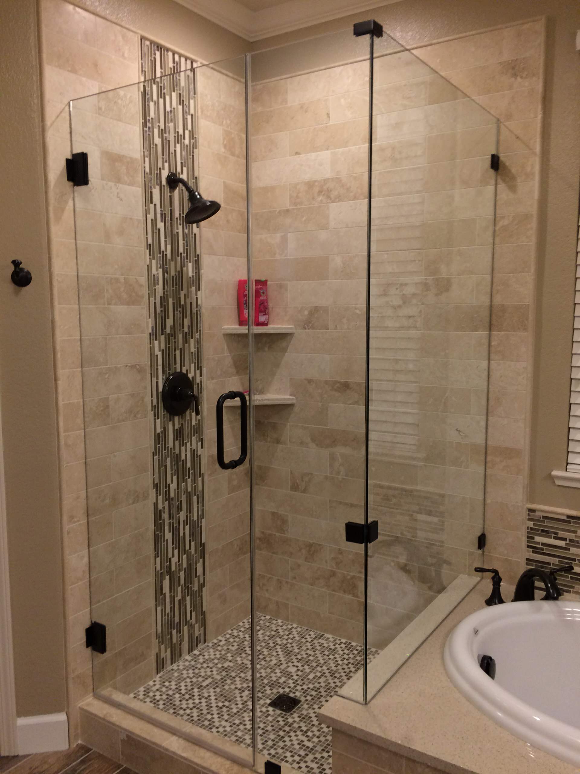 Tall custom shower enclosure with limestone tile walls.