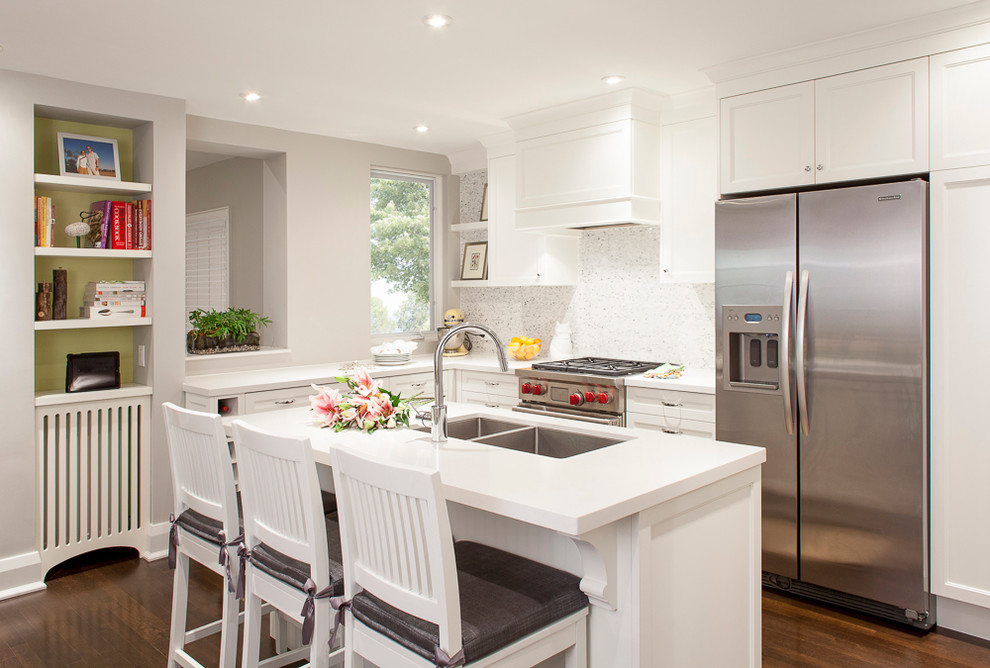 Contemporary kitchen in Toronto with quartz benchtops and stainless steel appliances.
