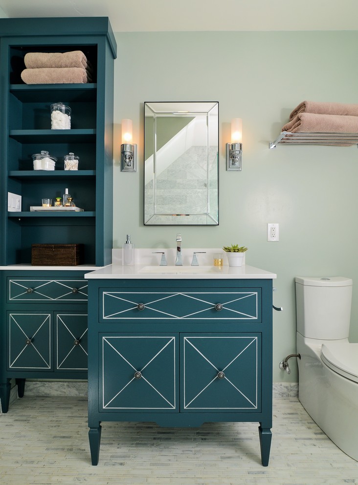 Transitional bathroom in Sacramento with blue cabinets, a two-piece toilet, green walls, marble floors and flat-panel cabinets.