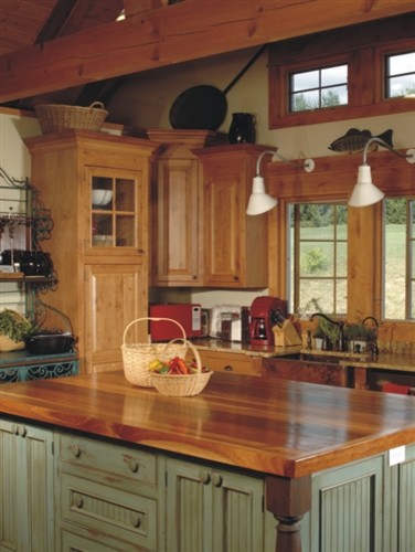 Mountain style kitchen photo in Orange County with a farmhouse sink, raised-panel cabinets, light wood cabinets, wood countertops and an island