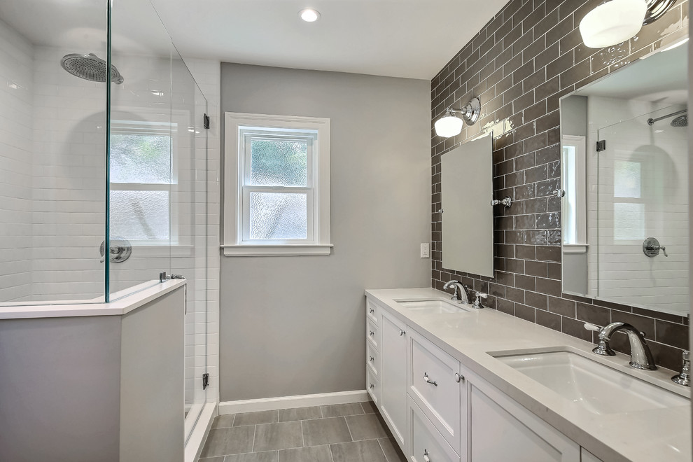 This is an example of a mid-sized transitional master bathroom in San Francisco with recessed-panel cabinets, white cabinets, a corner shower, gray tile, ceramic tile and an undermount sink.