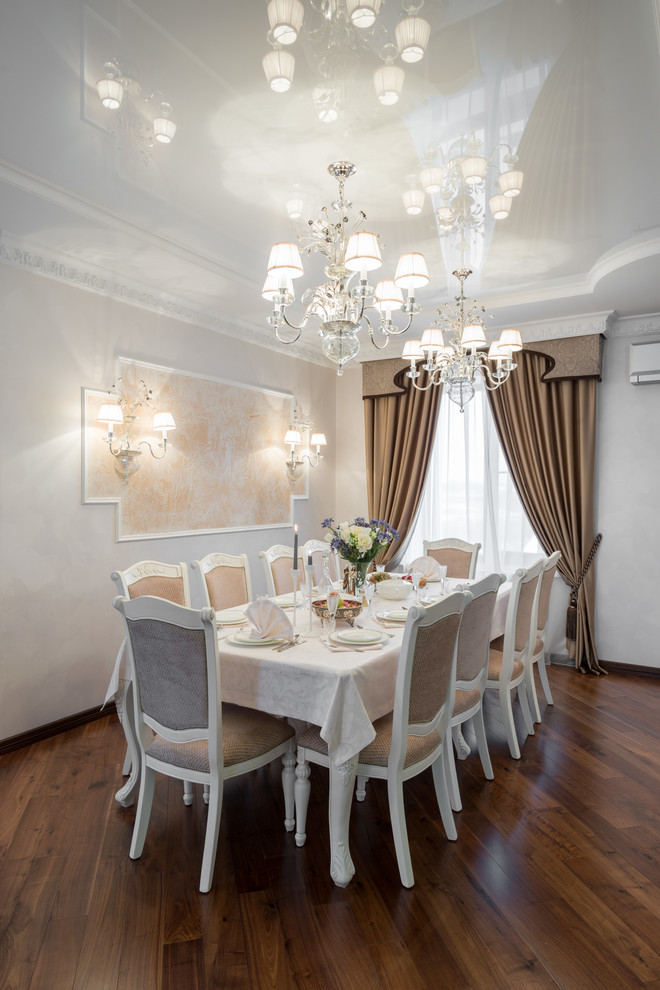 Photo of a transitional dining room in Novosibirsk with white walls, medium hardwood floors, no fireplace and brown floor.