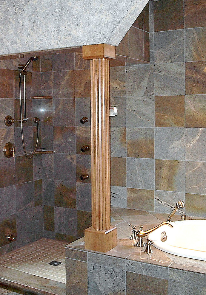 This is an example of a large traditional master bathroom in Other with raised-panel cabinets, light wood cabinets, a drop-in tub, an open shower, gray tile, ceramic tile, multi-coloured walls, an undermount sink, granite benchtops and a one-piece toilet.