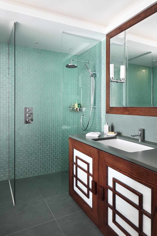 Photo of a mid-sized asian kids bathroom in Other with recessed-panel cabinets, dark wood cabinets, a corner shower, blue tile, green tile, an integrated sink, grey floor, an open shower and grey benchtops.
