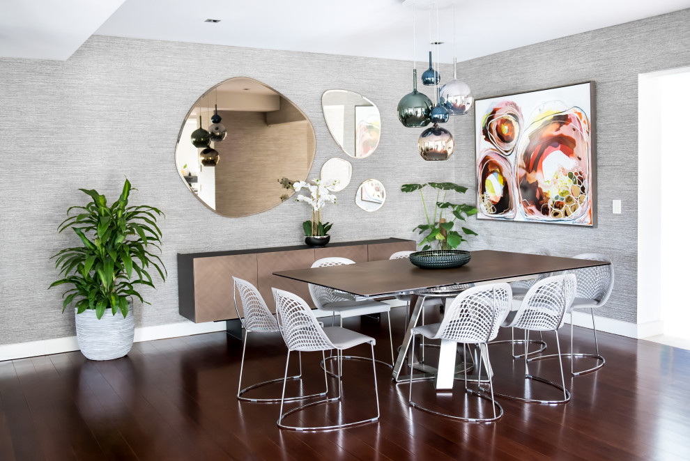 This is an example of a contemporary dining room in Sydney with grey walls, dark hardwood floors, brown floor and wallpaper.