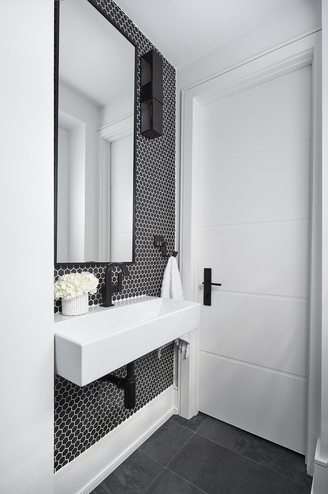 Photo of a small contemporary powder room in Toronto with black and white tile, porcelain tile, black walls, slate floors, a wall-mount sink and black floor.