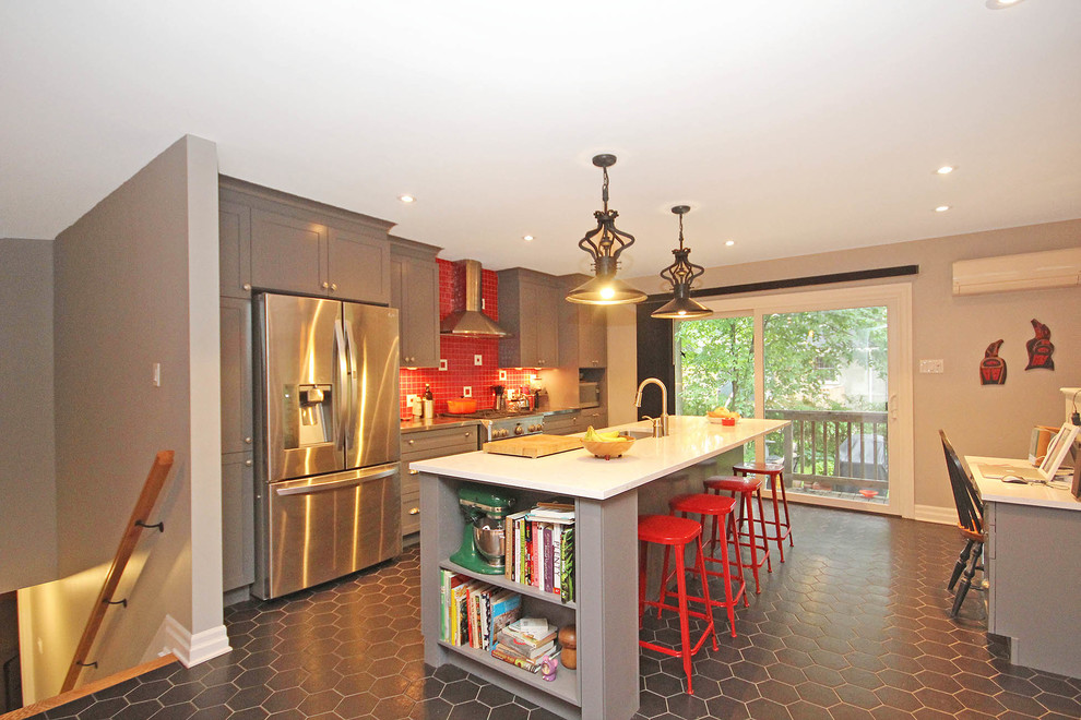 Photo of a mid-sized eclectic galley eat-in kitchen in Ottawa with an undermount sink, recessed-panel cabinets, grey cabinets, quartz benchtops, red splashback, ceramic splashback, stainless steel appliances, ceramic floors and with island.