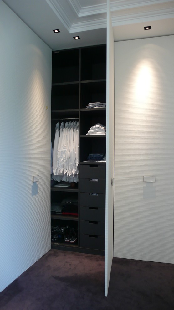 Design ideas for a large contemporary men's built-in wardrobe in Paris with flat-panel cabinets, white cabinets and carpet.
