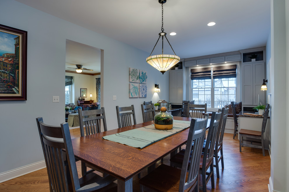 Photo of a mid-sized arts and crafts open plan dining in Chicago with light hardwood floors.