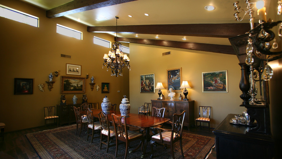 Design ideas for a mid-sized traditional separate dining room in Phoenix with yellow walls, dark hardwood floors and no fireplace.