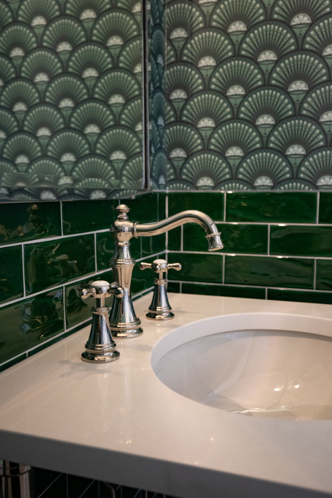Inspiration for a mid-sized transitional green tile and ceramic tile mosaic tile floor, multicolored floor and wallpaper powder room remodel with a one-piece toilet, green walls, an undermount sink, solid surface countertops and white countertops