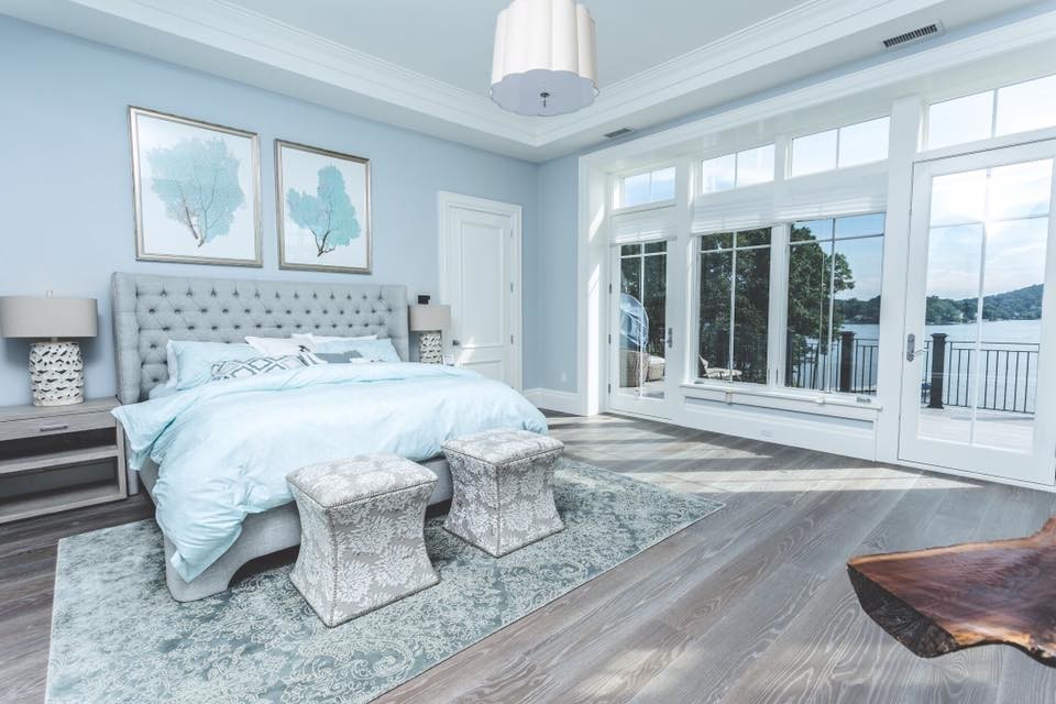 Inspiration for a large transitional master medium tone wood floor and brown floor bedroom remodel in New York with blue walls and no fireplace