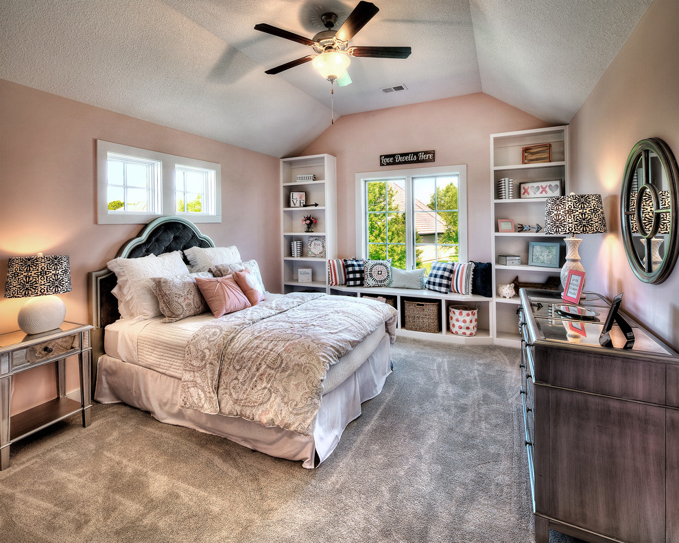 This is an example of a transitional bedroom in Kansas City with pink walls, carpet and grey floor.