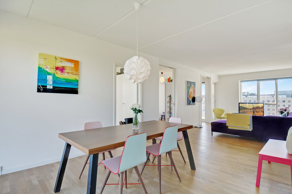Photo of a mid-sized modern separate dining room in Copenhagen with white walls, light hardwood floors and no fireplace.