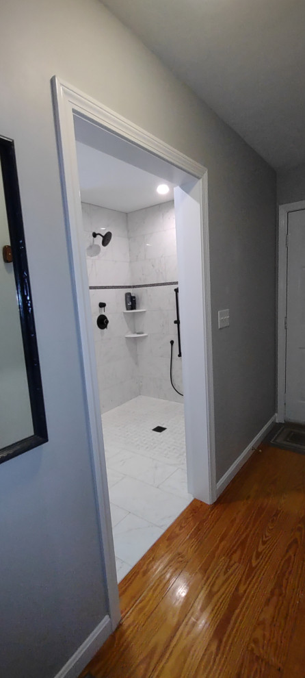 Photo of a modern bathroom in Boston with a curbless shower, white tile and porcelain tile.