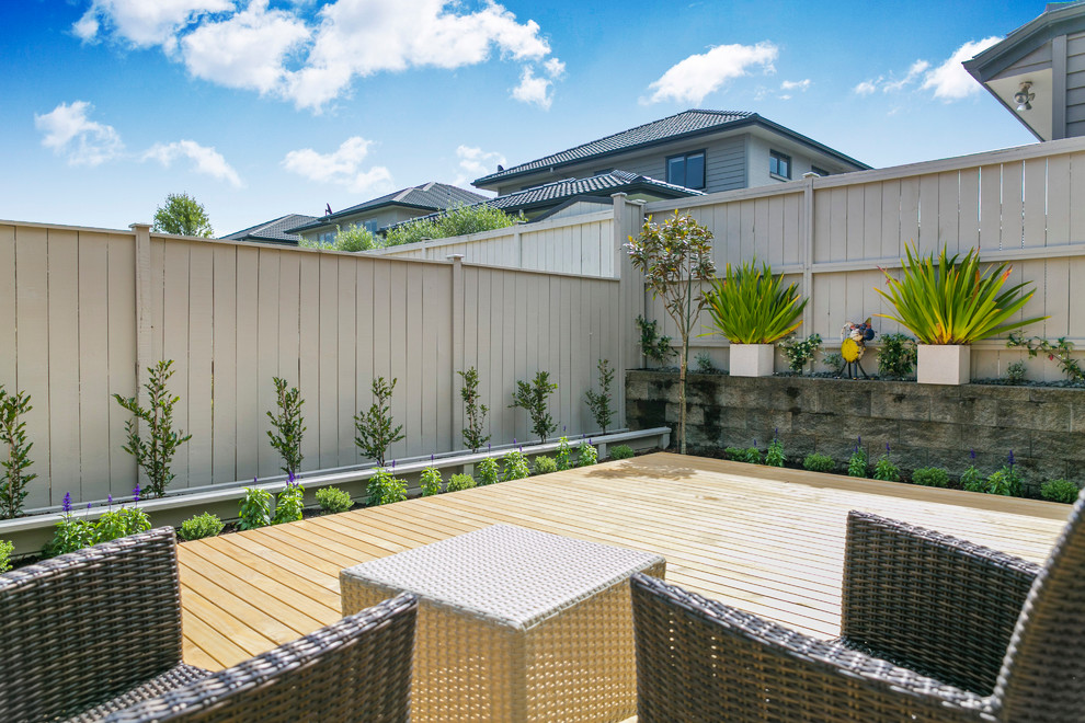This is an example of a small contemporary backyard partial sun garden in Auckland with decking.