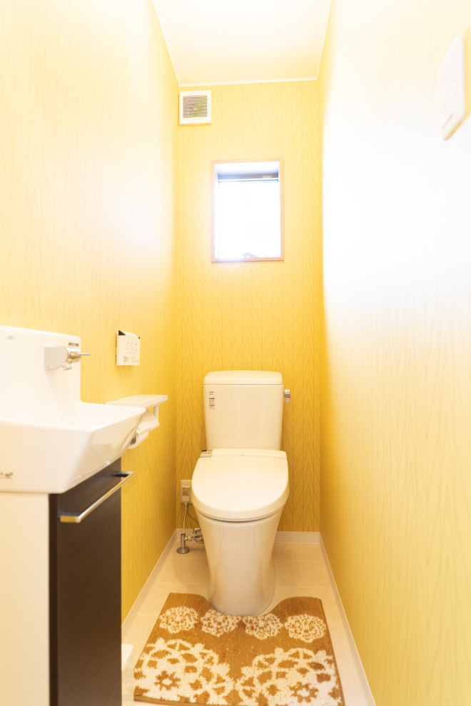 Design ideas for a small contemporary powder room in Other with vinyl floors, white benchtops, flat-panel cabinets, dark wood cabinets, a two-piece toilet, yellow walls, a wall-mount sink, solid surface benchtops and white floor.