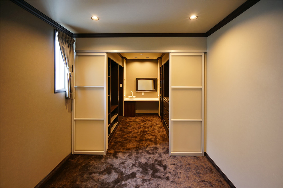 Идея дизайна: большая гардеробная комната унисекс в стиле модернизм с коричневыми фасадами, коричневым полом и потолком с обоями