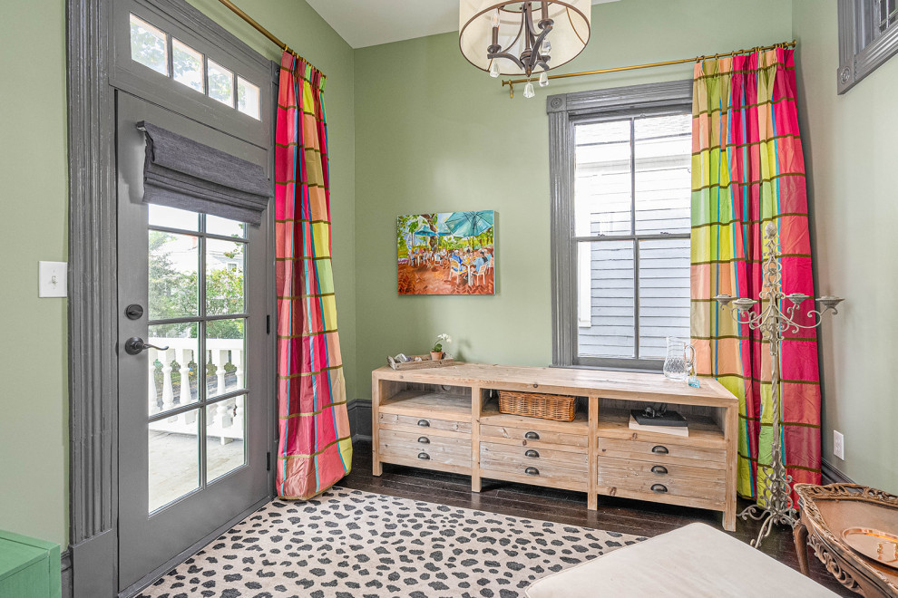 Example of a mid-sized transitional master dark wood floor and black floor bedroom design with green walls
