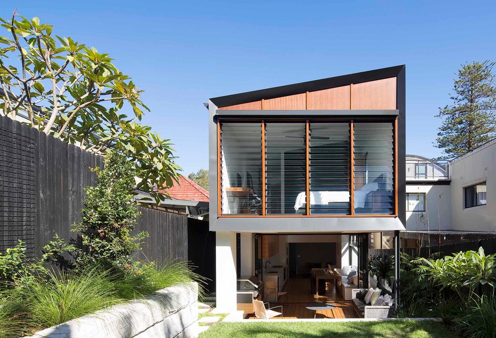 Photo of a modern two-storey house exterior in Sydney with wood siding.