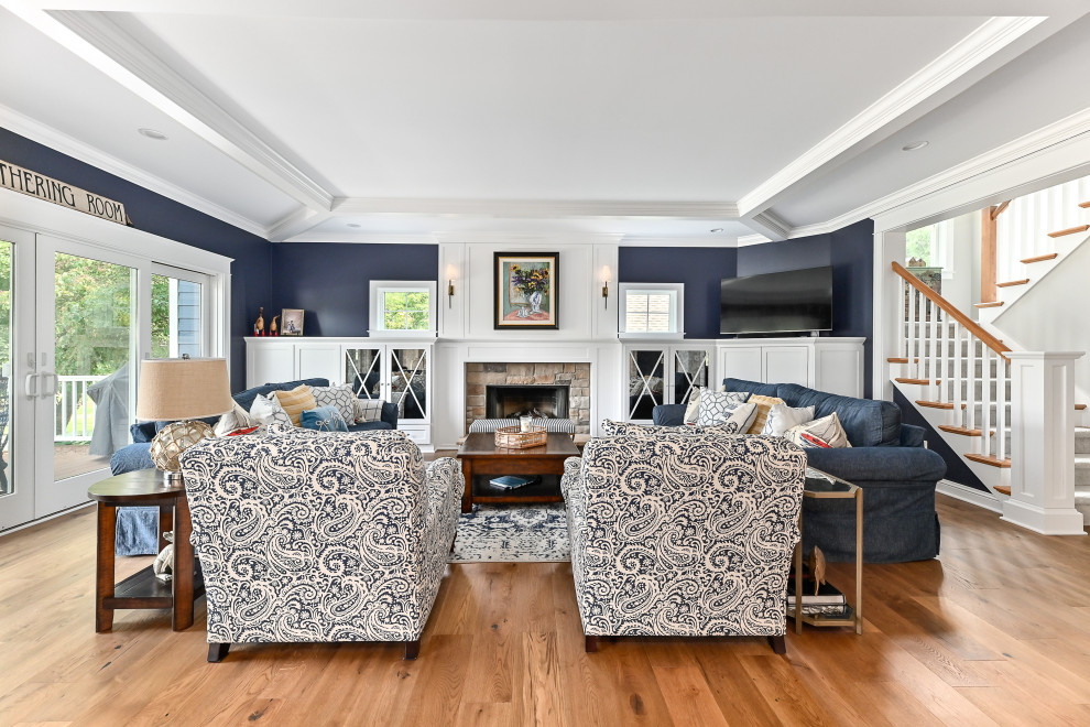 Inspiration for an expansive transitional formal open concept living room in Milwaukee with blue walls, vinyl floors, a standard fireplace, a stone fireplace surround, a wall-mounted tv, brown floor and coffered.