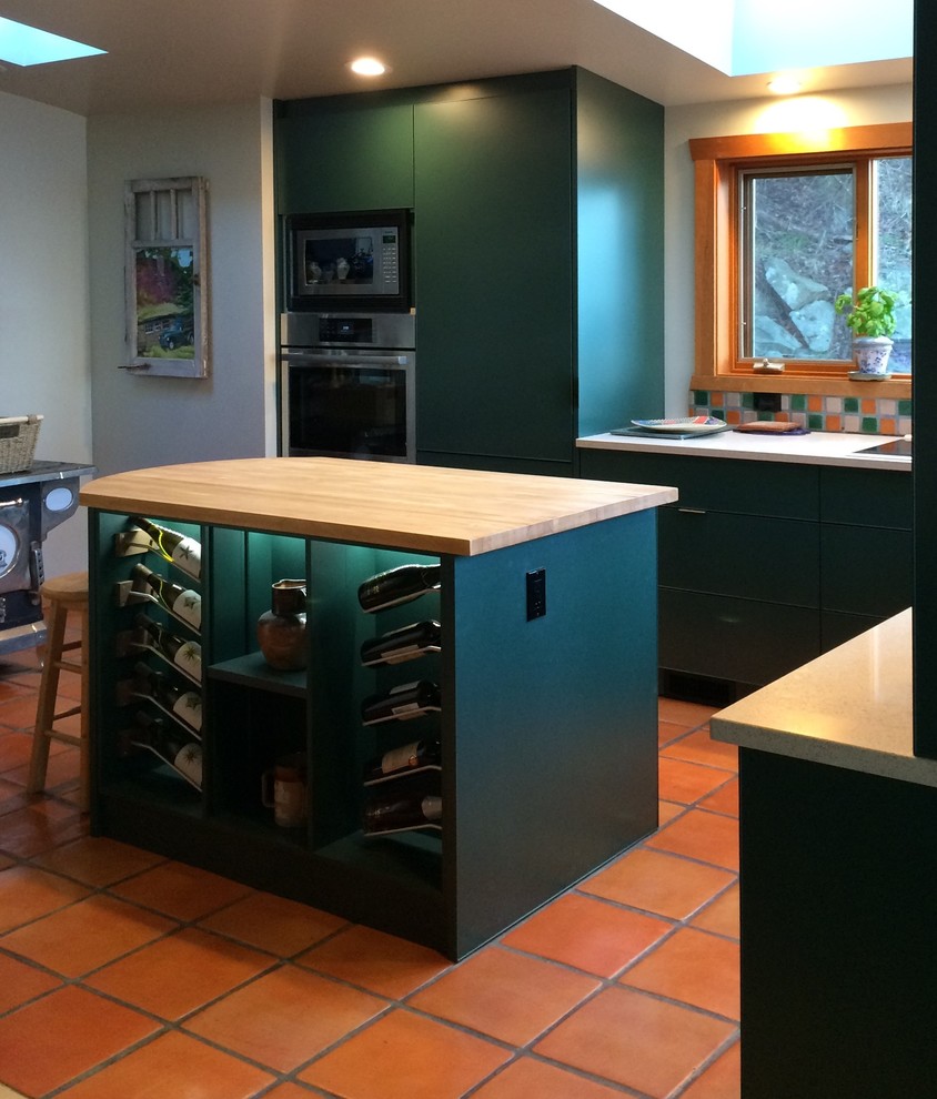 Large mountain style l-shaped terra-cotta tile open concept kitchen photo in Vancouver with an undermount sink, flat-panel cabinets, green cabinets, quartz countertops, terra-cotta backsplash and an island
