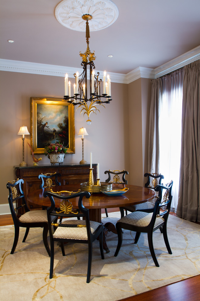 Photo of a mid-sized traditional separate dining room in New Orleans with beige walls, dark hardwood floors, no fireplace and brown floor.