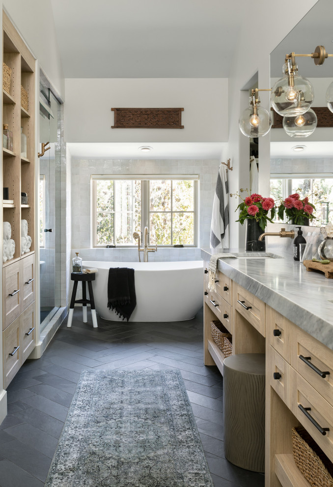 Inspiration for a large country master bathroom in Denver with brown cabinets, a freestanding tub, a corner shower, gray tile, glass tile, grey walls, slate floors, an undermount sink, grey floor, a hinged shower door, grey benchtops, a double vanity, a freestanding vanity, vaulted and shaker cabinets.